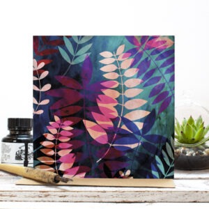 Greetings card featuring bold colourful layered palm leaves in pink, blue and green.